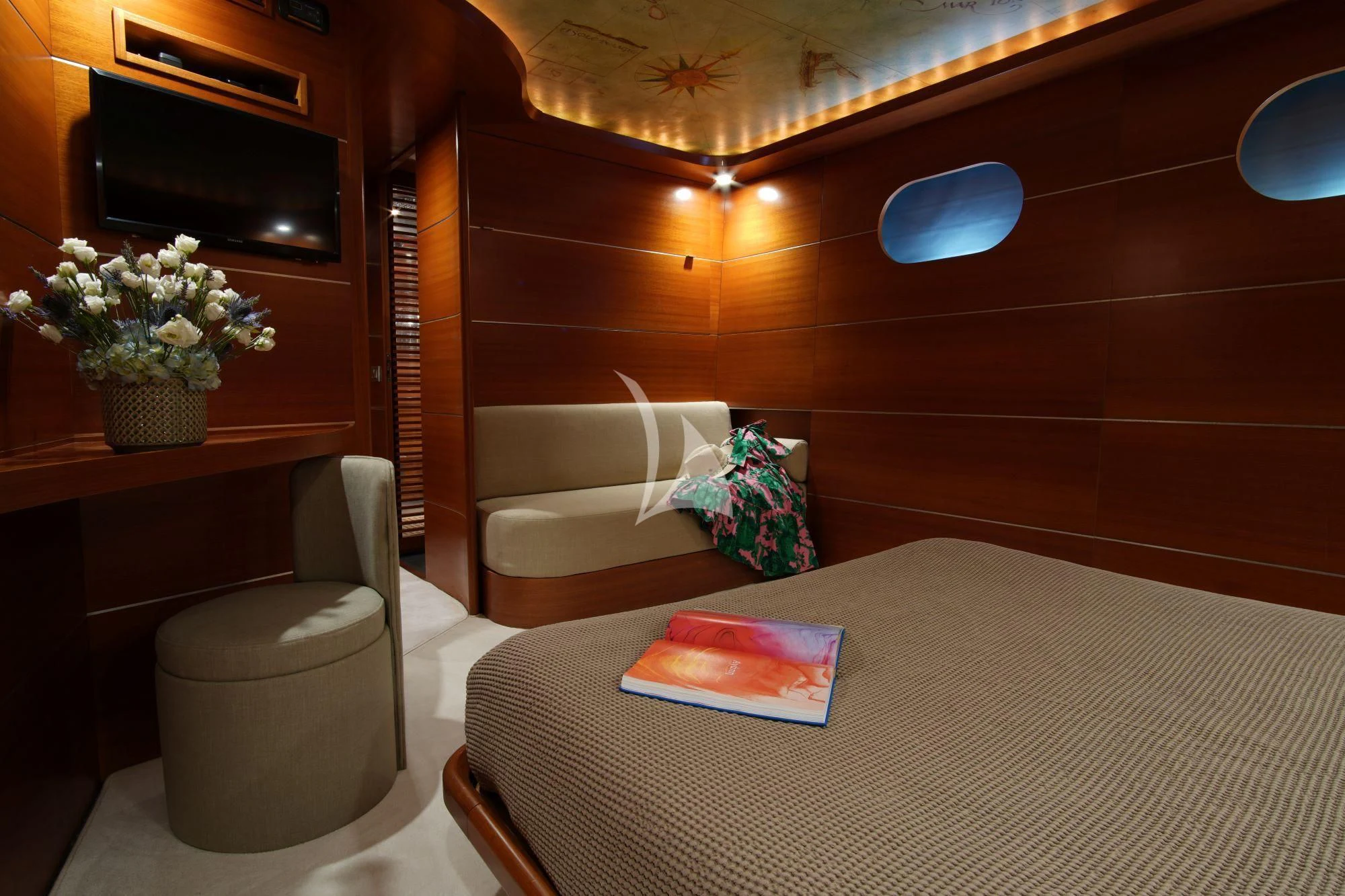 a room with a bed and a table aboard SATORI Yacht for Sale