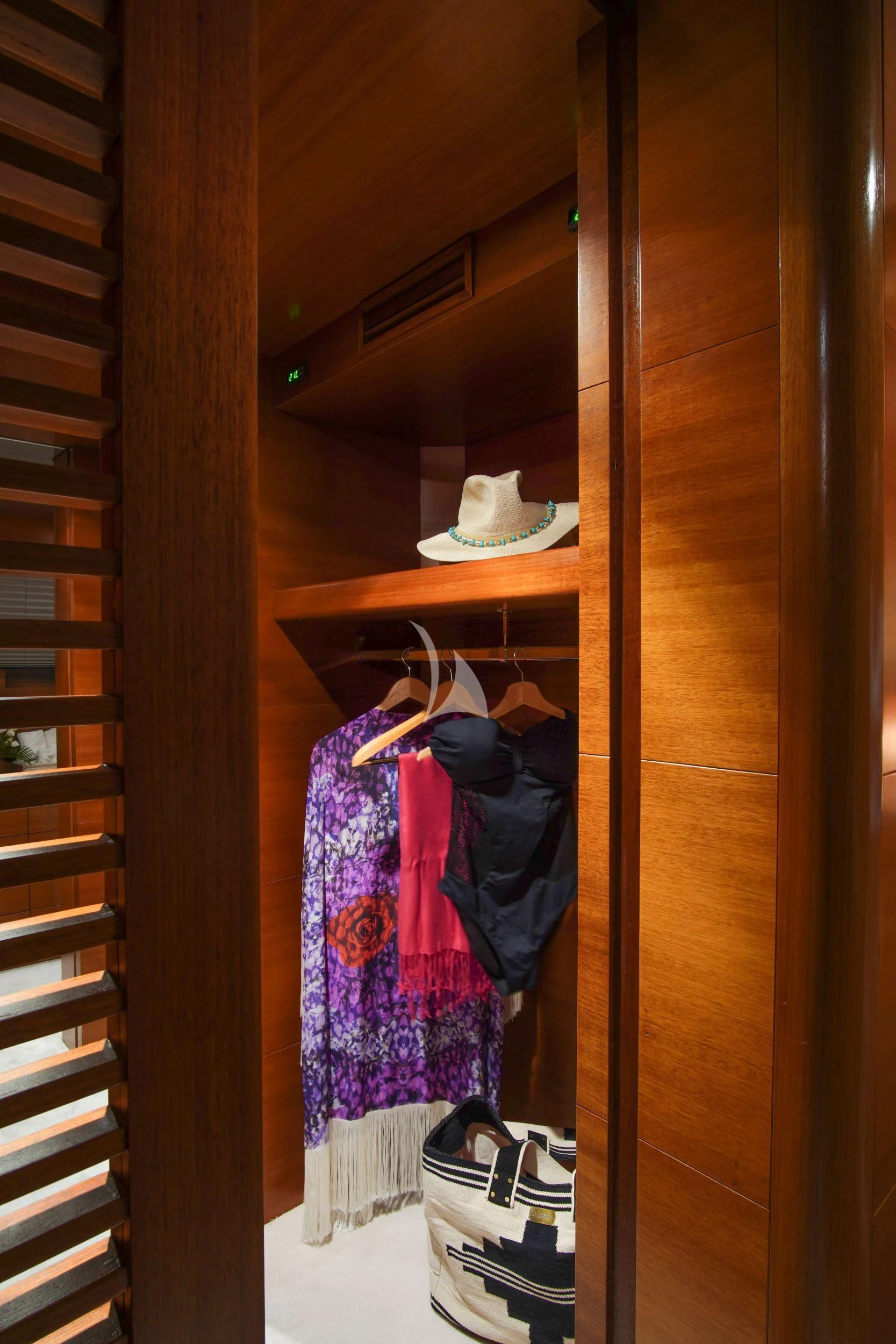 a closet with clothes and shoes aboard SATORI Yacht for Sale
