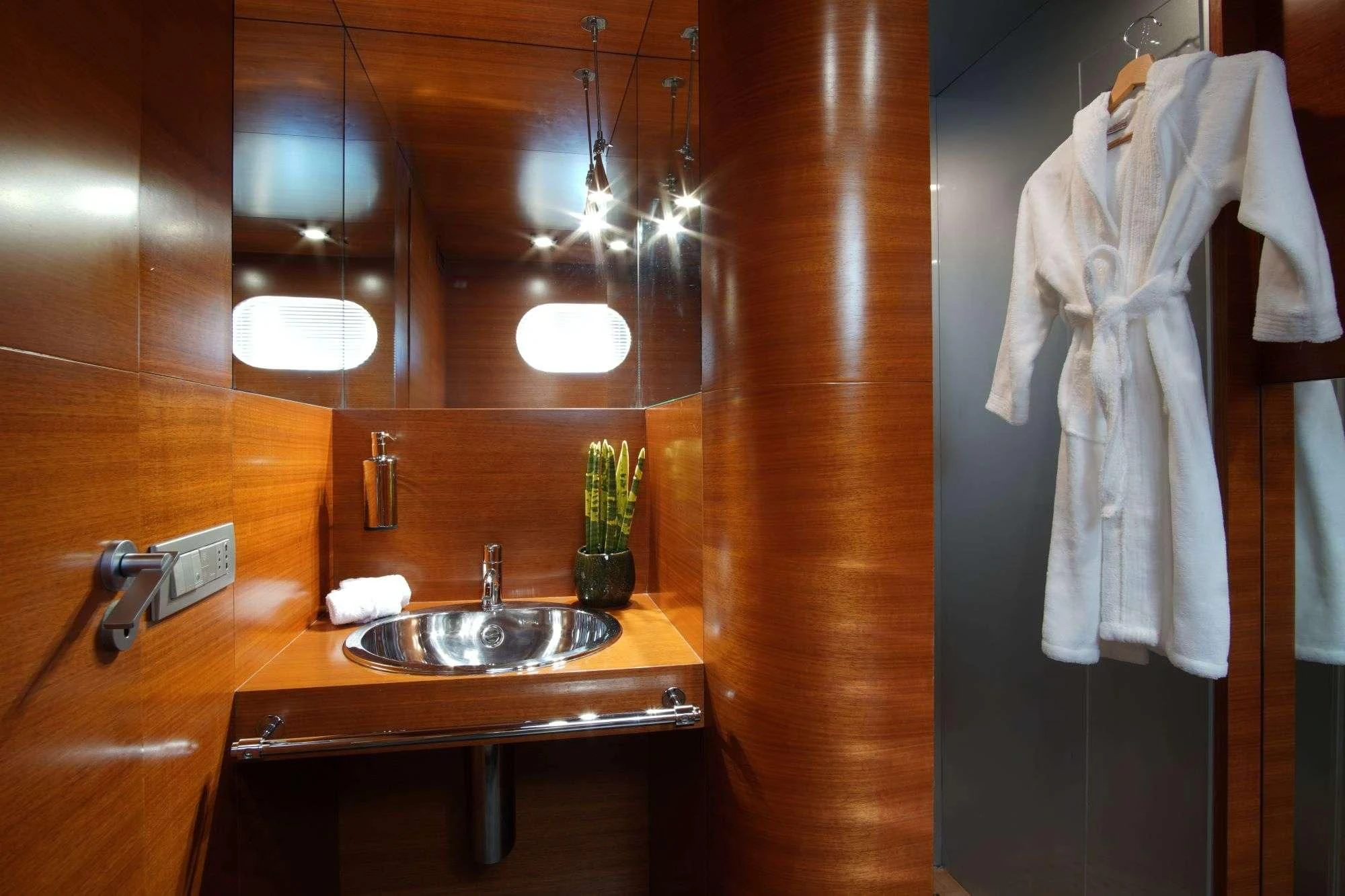 a bathroom with a sink and a towel from the ceiling aboard SATORI Yacht for Sale