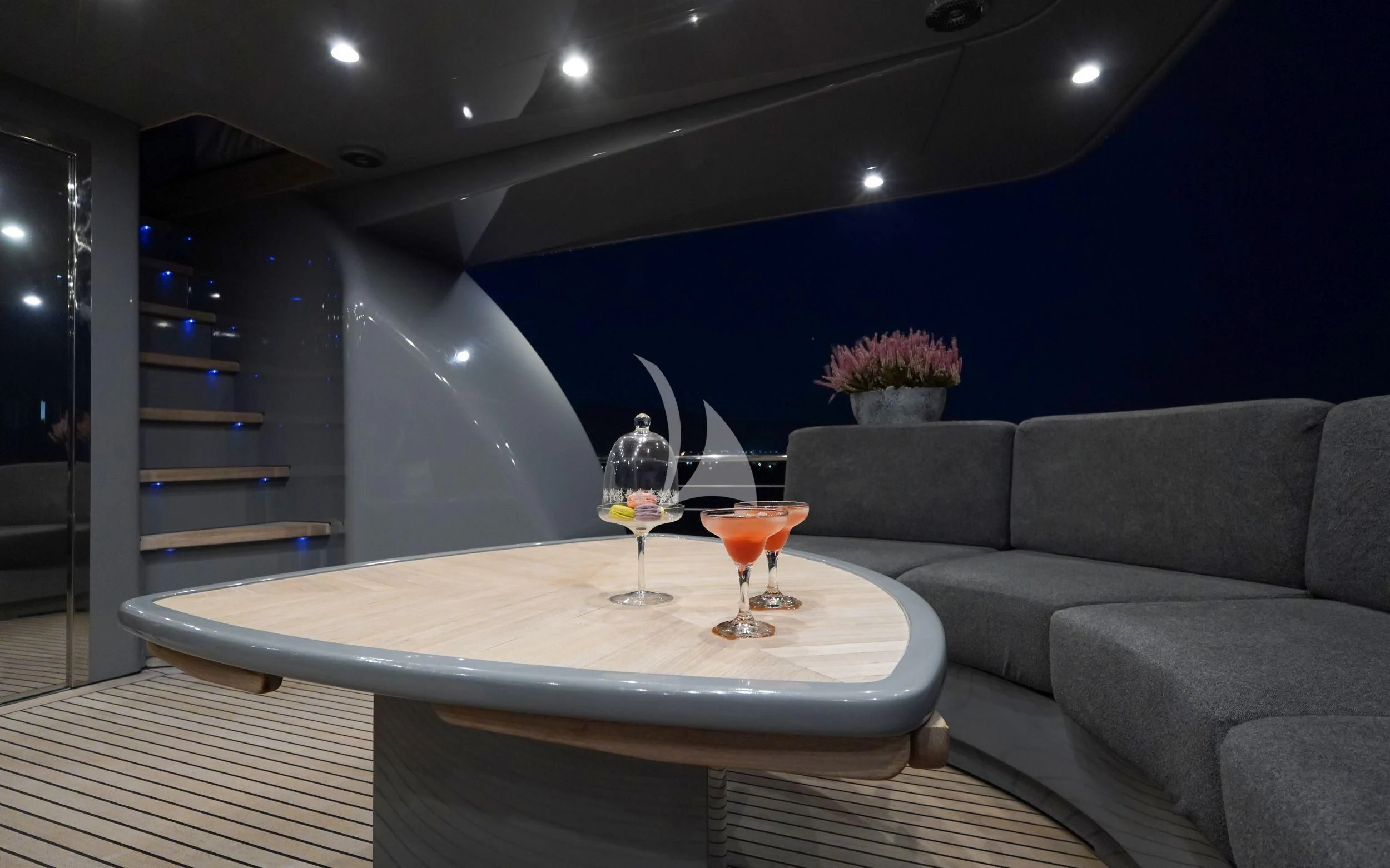 a room with a couch and a table with glasses on it aboard SATORI Yacht for Sale