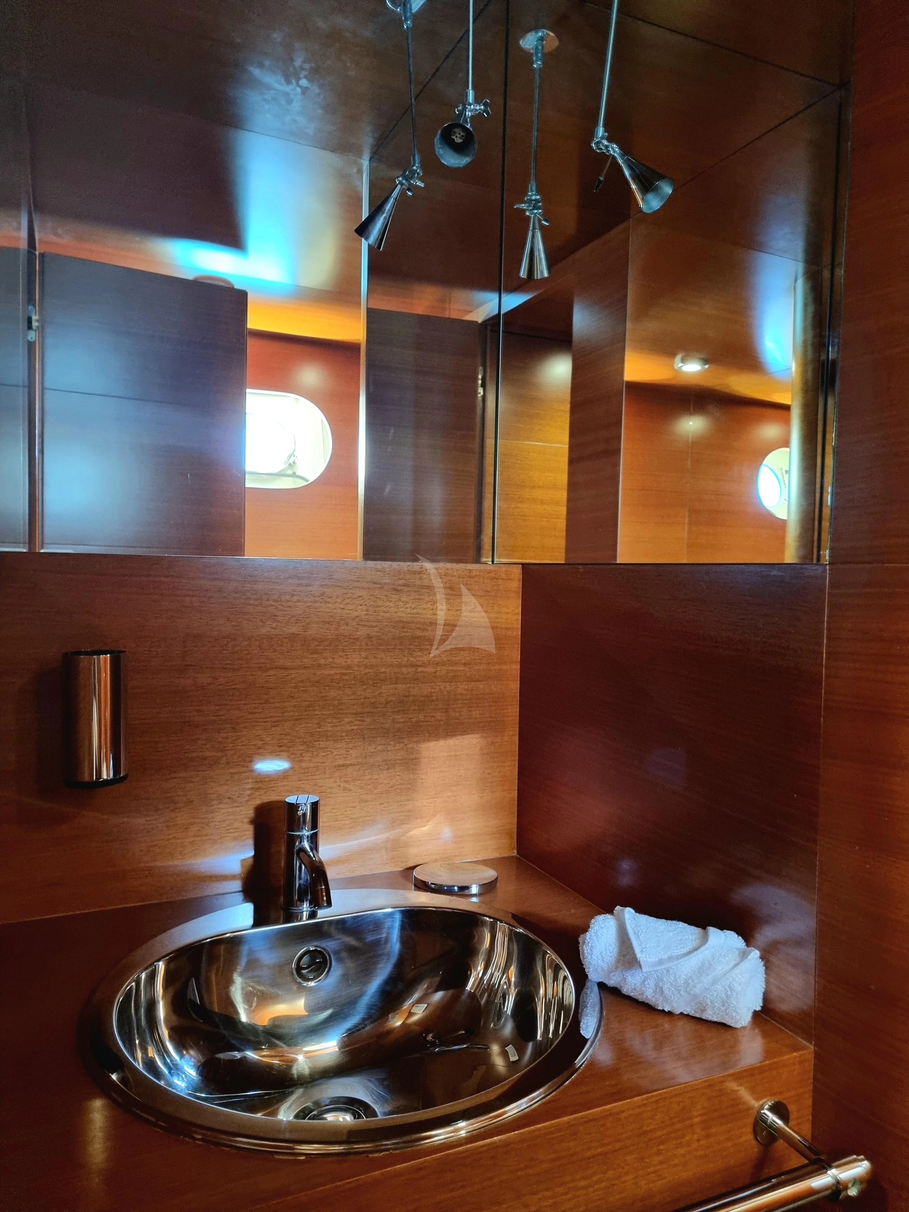 a bathroom sink with a large mirror aboard SATORI Yacht for Sale