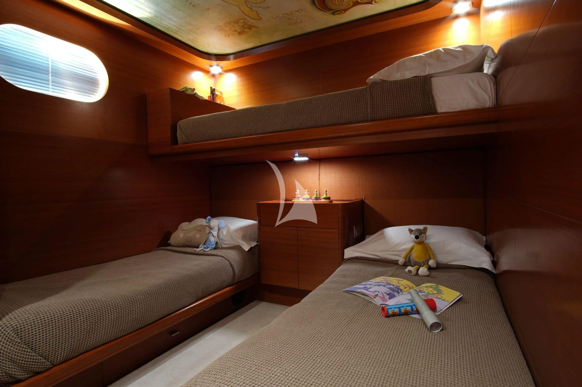 a room with two beds and a stuffed animal aboard SATORI Yacht for Sale