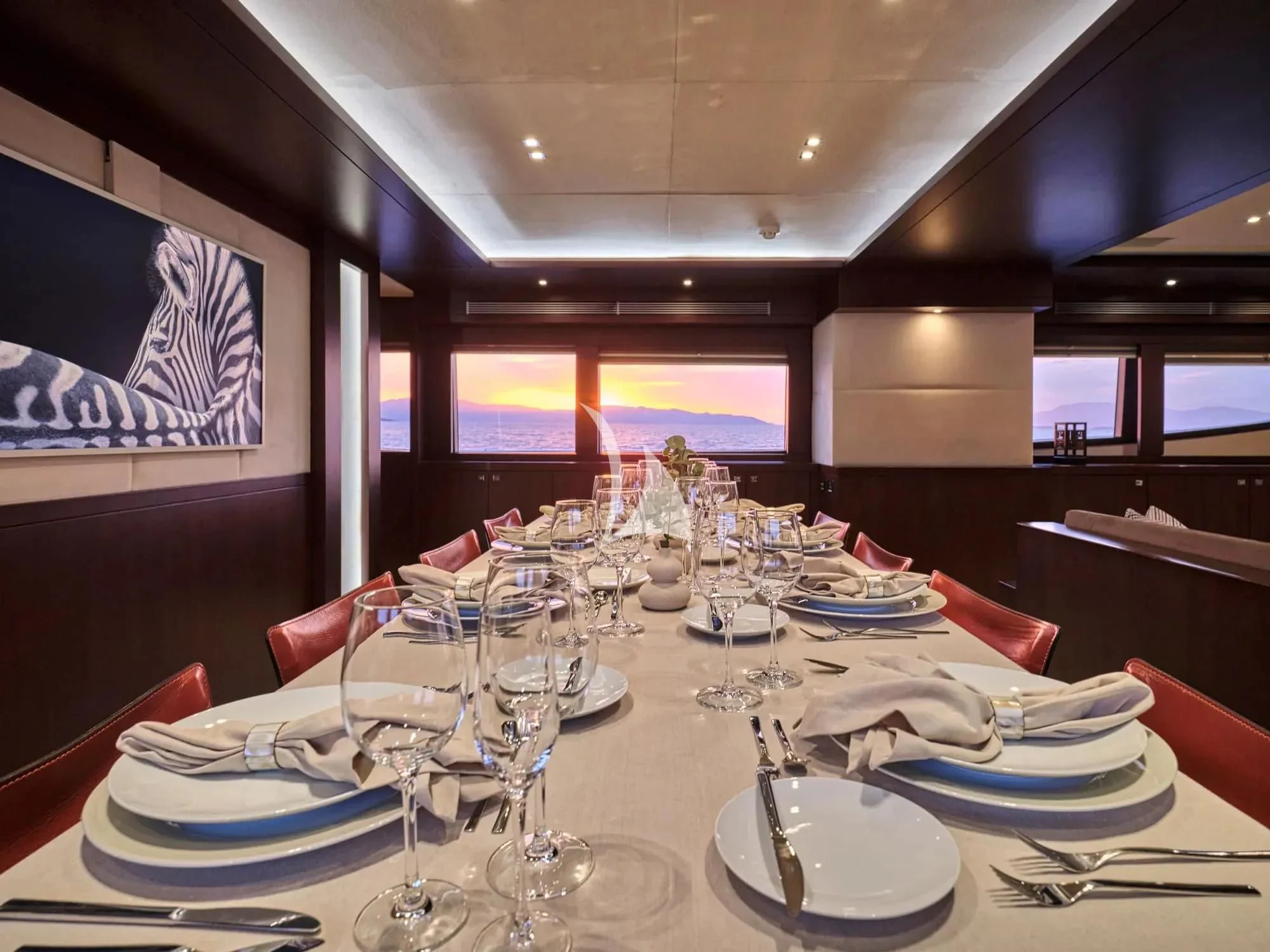 a table with plates and glasses aboard SANJANA Yacht for Sale