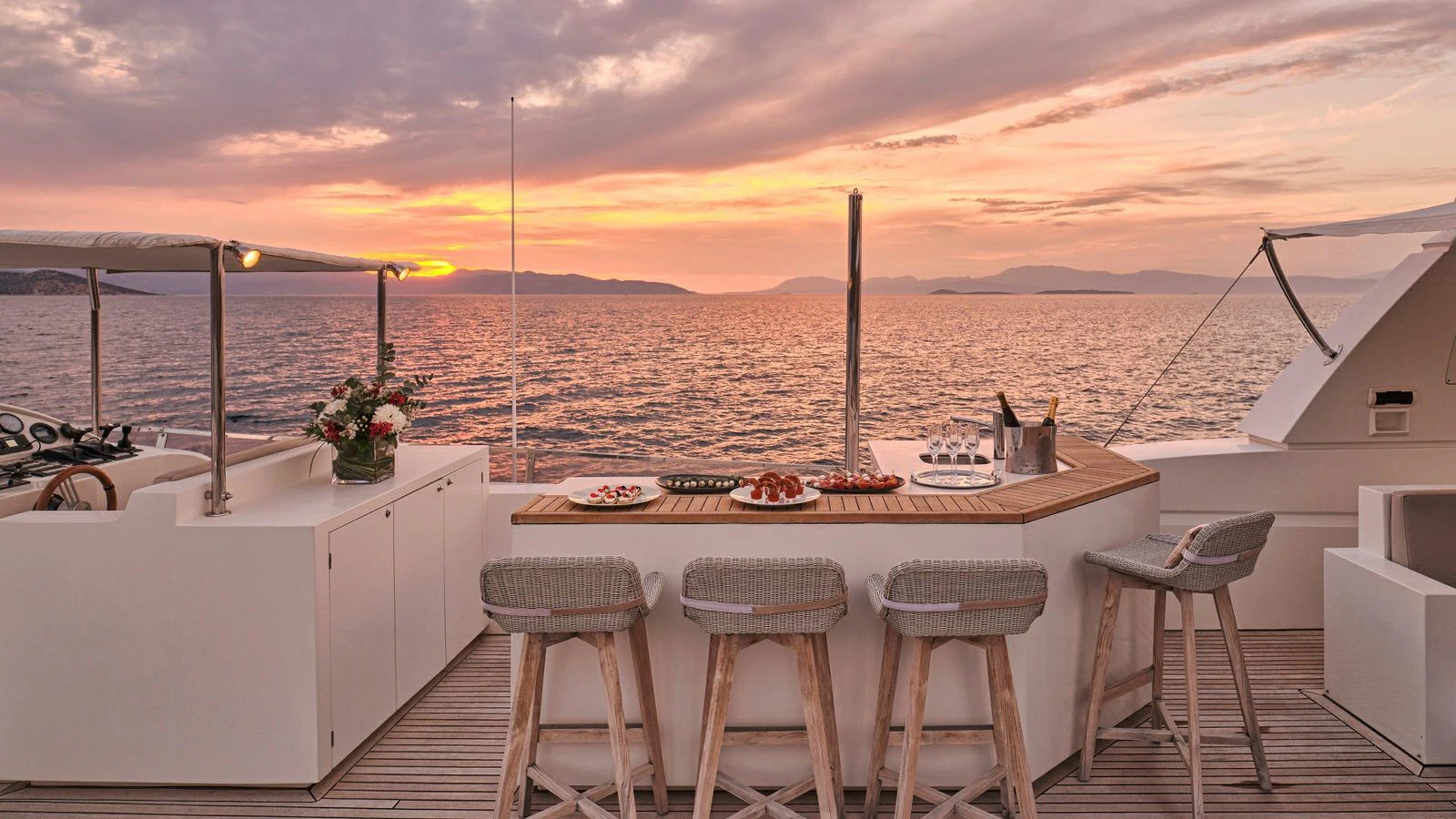 a table with chairs and a view of the ocean aboard SANJANA Yacht for Sale