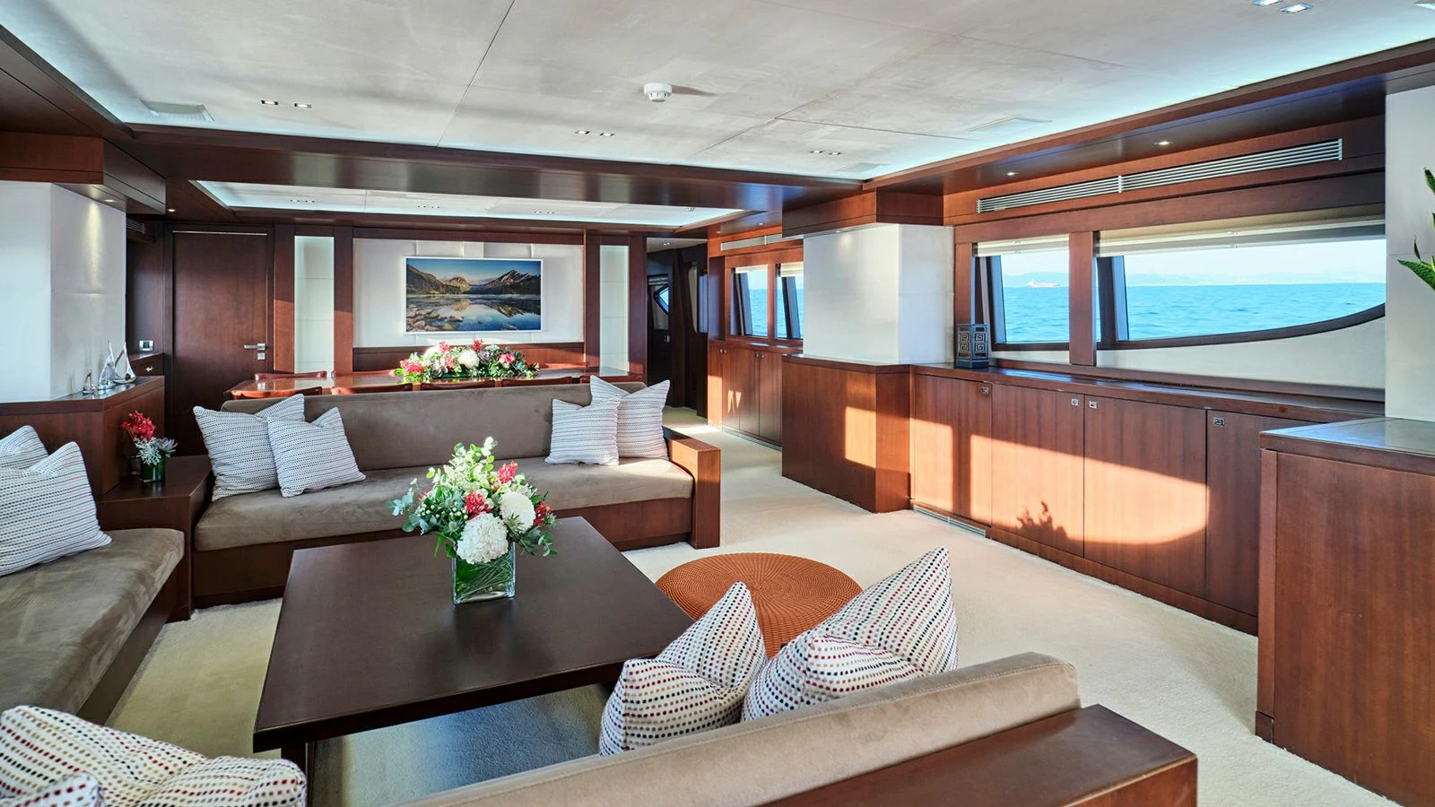 a living room with a couch and a table aboard SANJANA Yacht for Sale