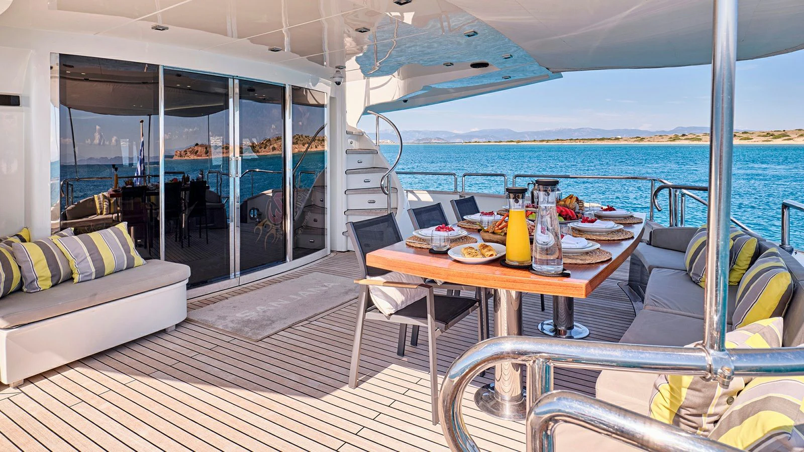 a boat with a table and chairs aboard SANJANA Yacht for Sale