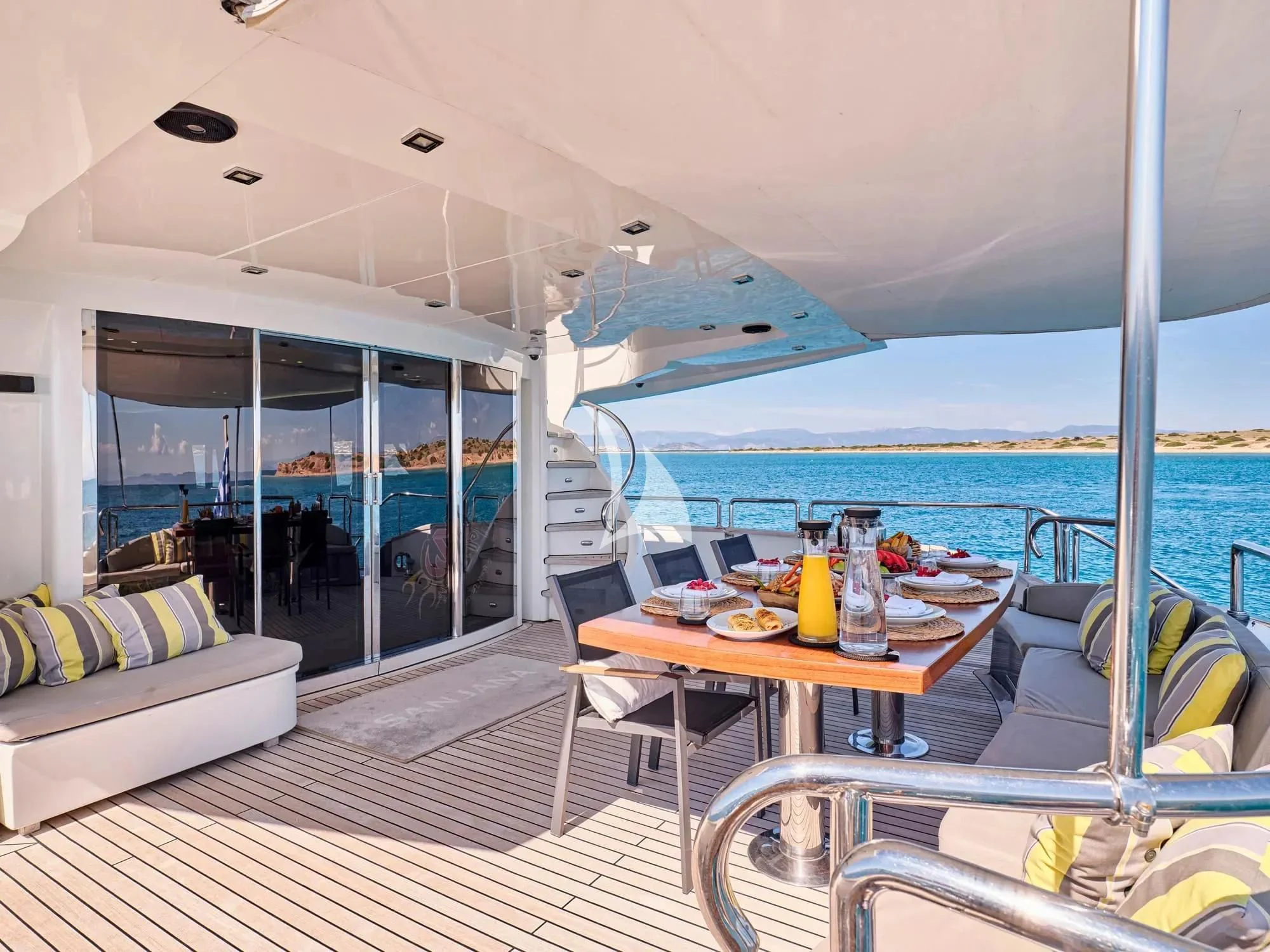 a boat with a table and chairs aboard SANJANA Yacht for Sale