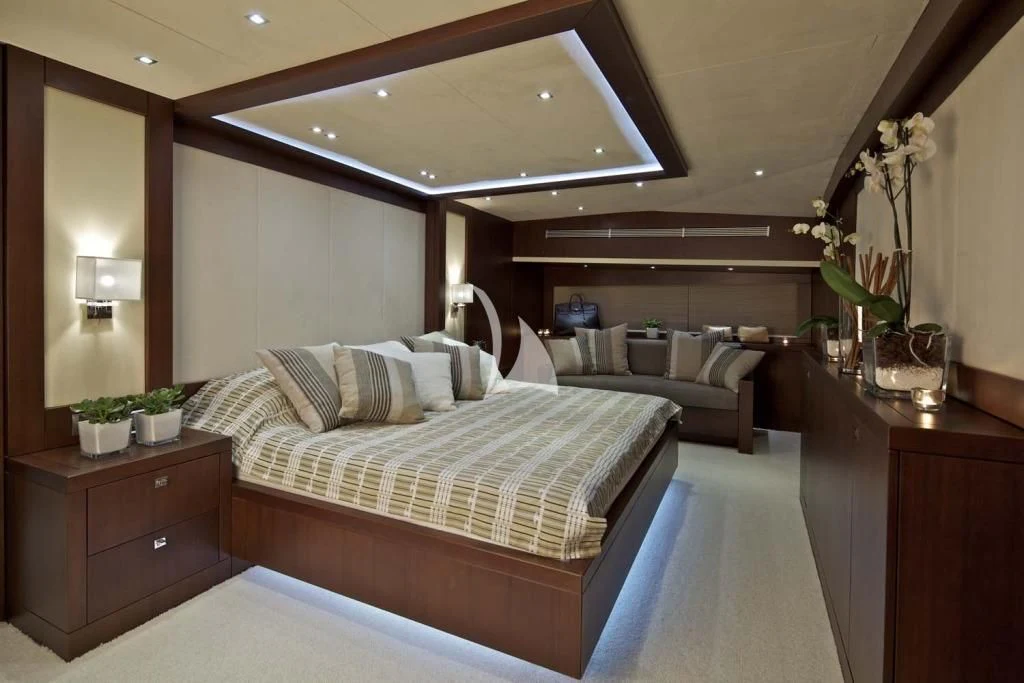 a bedroom with a bed and a couch aboard SANJANA Yacht for Sale