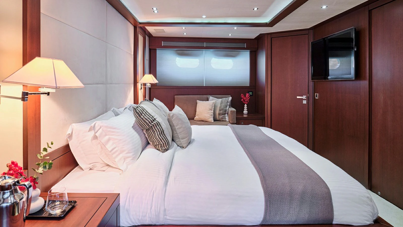 a bed with white sheets and pillows aboard SANJANA Yacht for Sale