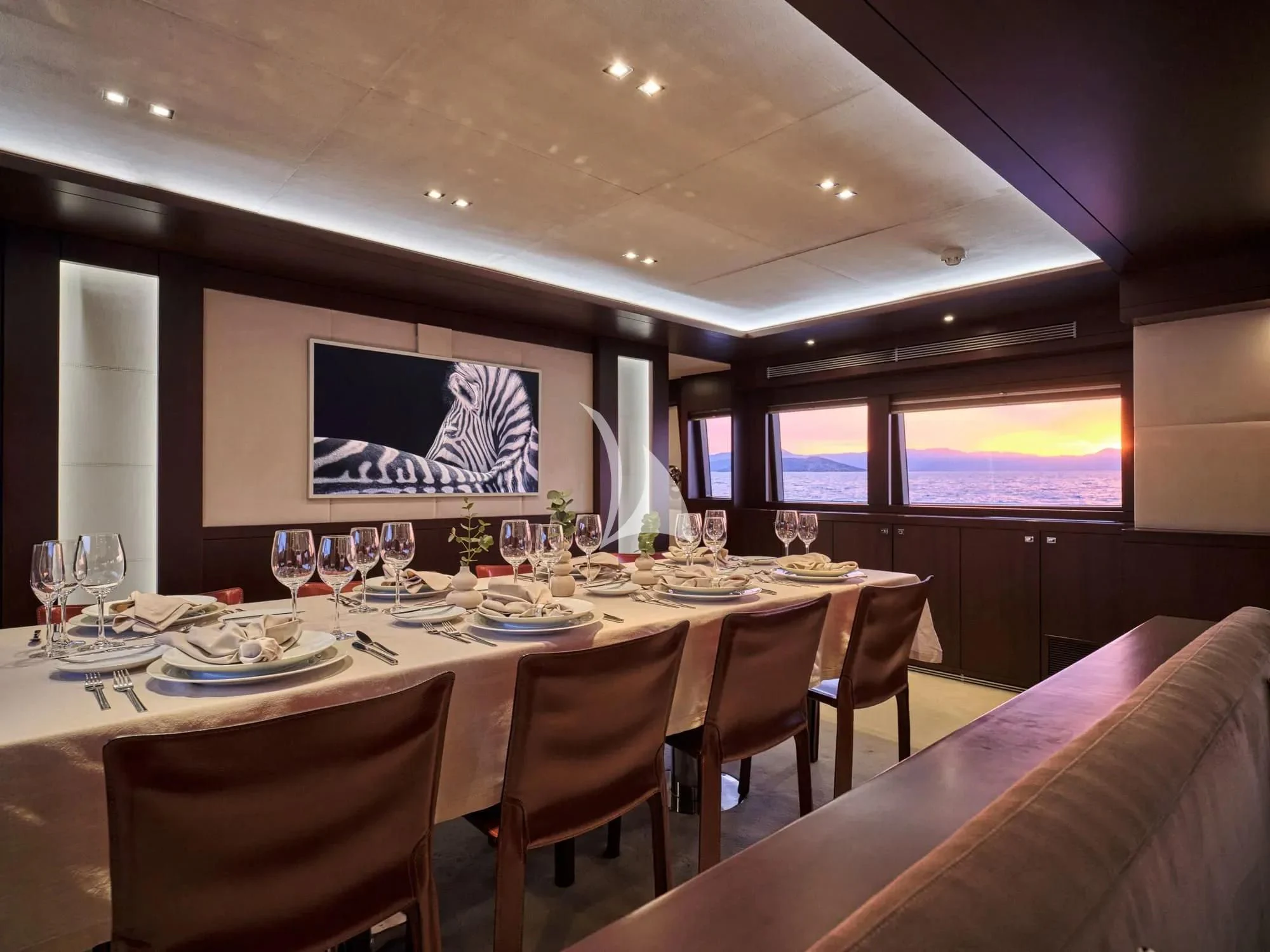 a table with a plate of food and glasses on it aboard SANJANA Yacht for Sale