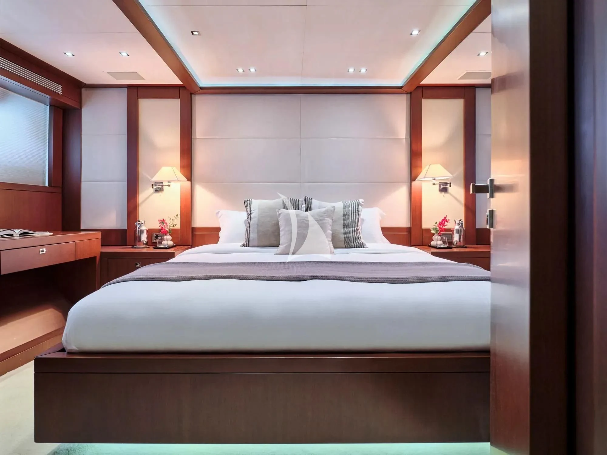 a bed with a white bed spread aboard SANJANA Yacht for Sale