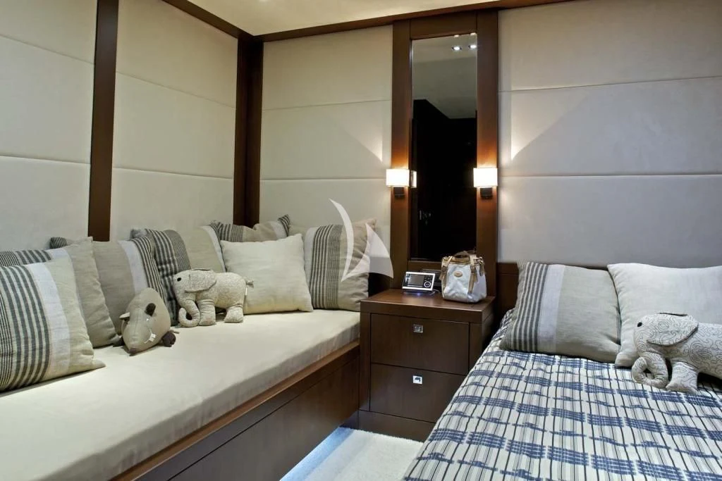 a bedroom with a bed and teddy bears aboard SANJANA Yacht for Sale