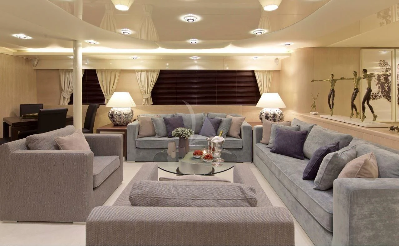 a living room with couches and a coffee table aboard MAGIX Yacht for Sale