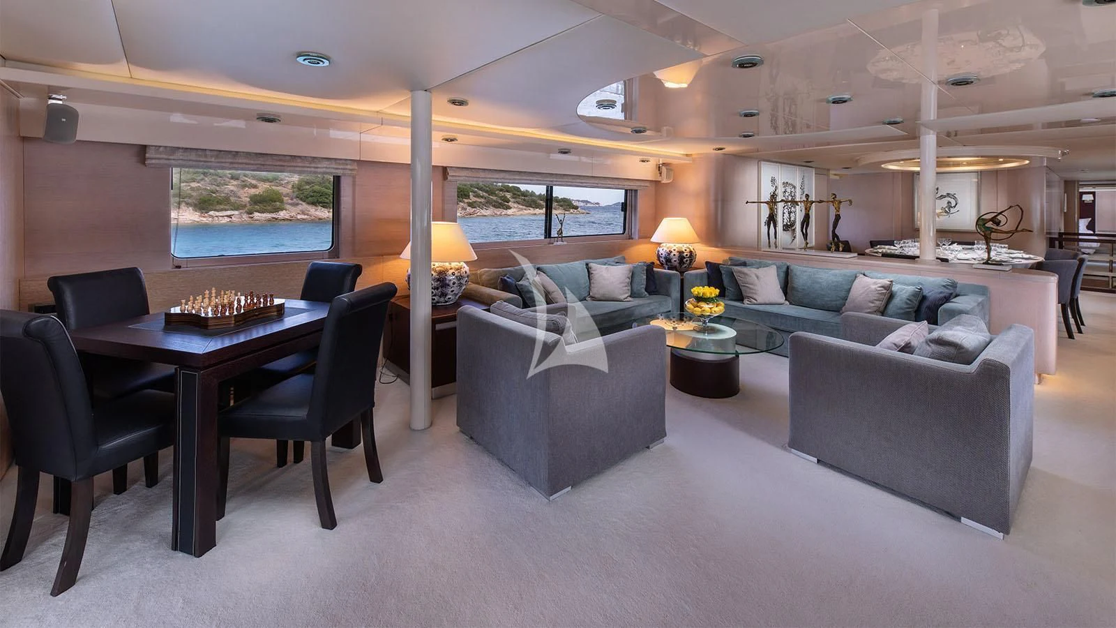 a living room with a couch and a table aboard MAGIX Yacht for Sale