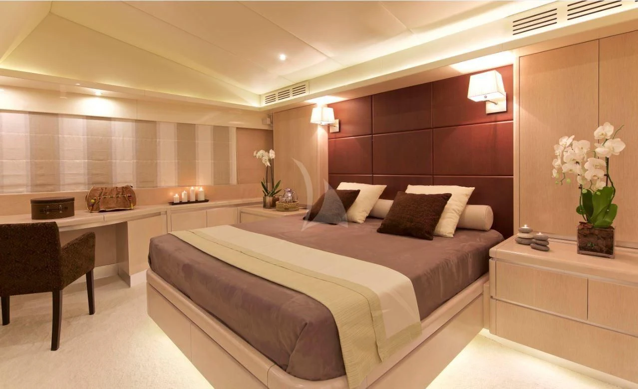 a room with a bed and desk aboard MAGIX Yacht for Sale