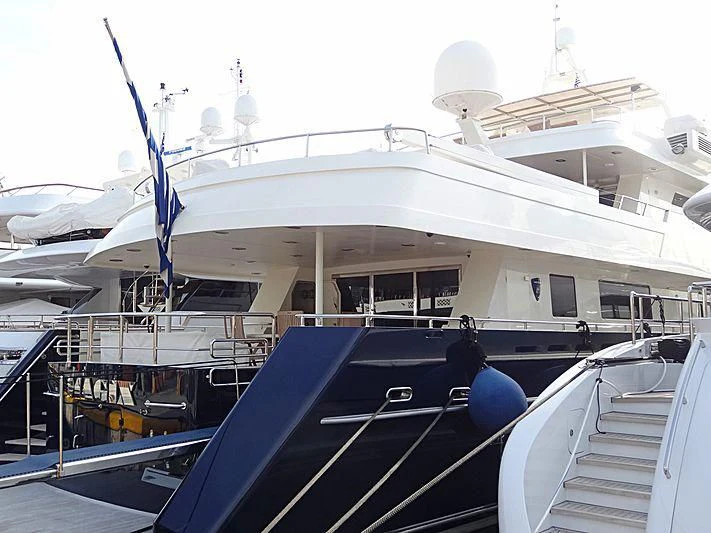 a large white boat with a blue crane on the deck aboard MAGIX Yacht for Sale