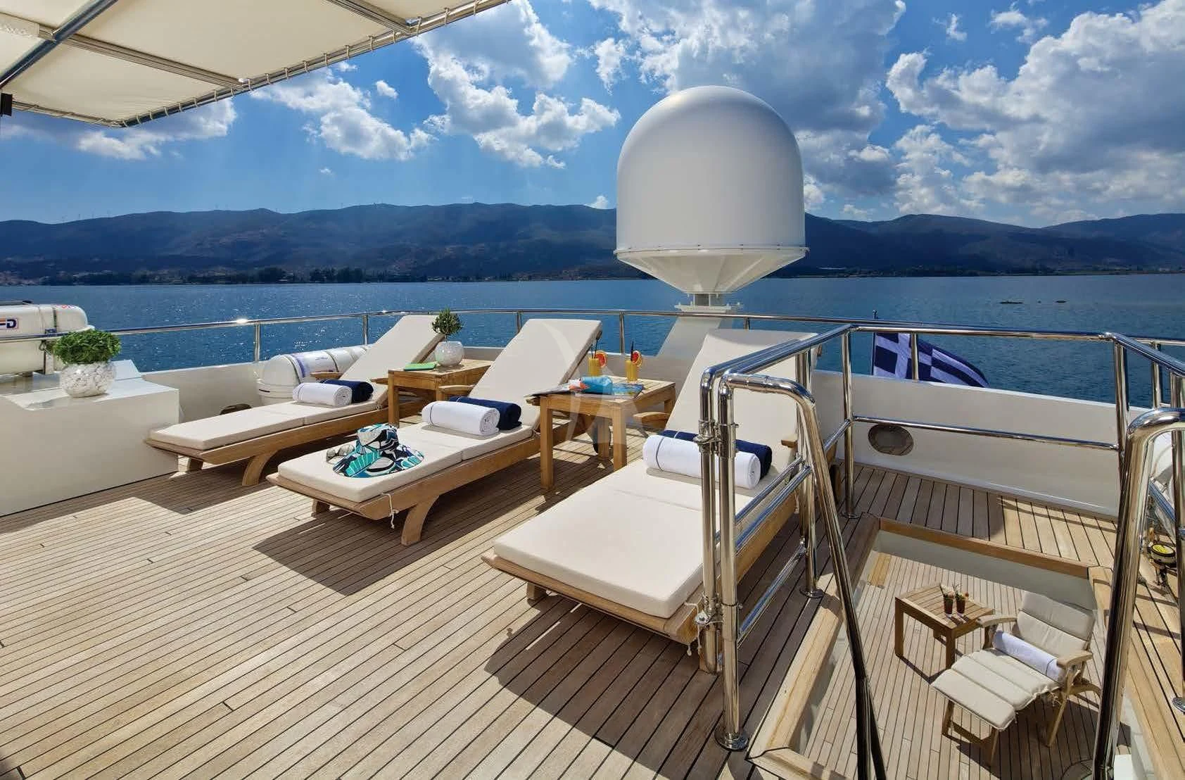 a deck with a large white hat on it and a table with chairs on it aboard MAGIX Yacht for Sale