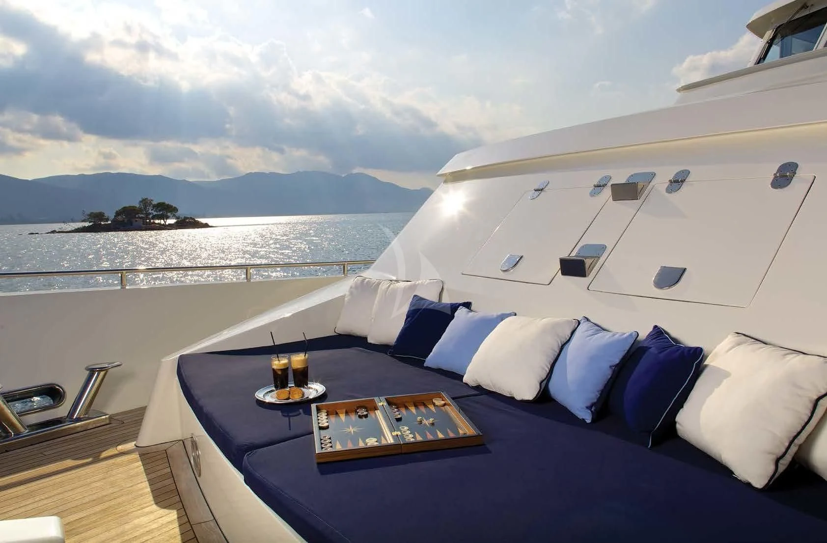 a bed with a blue blanket and pillows on it aboard MAGIX Yacht for Sale