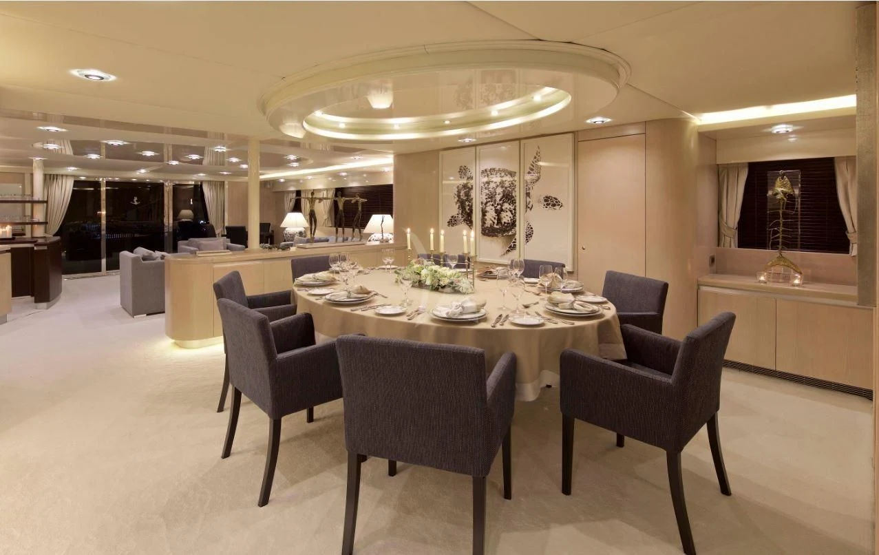 a large room with a table and chairs aboard MAGIX Yacht for Sale