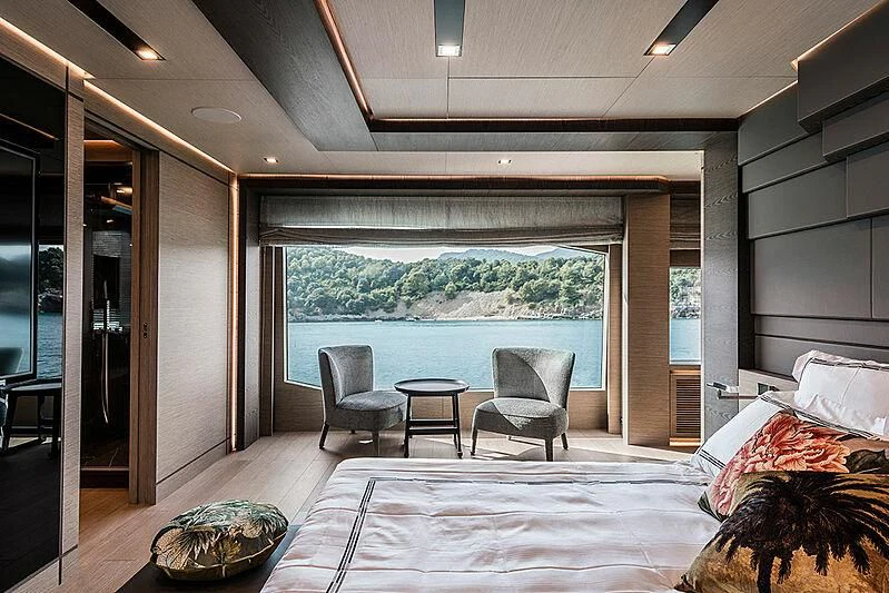 a room with a bed and a table and chairs aboard LADY NINA Yacht for Sale