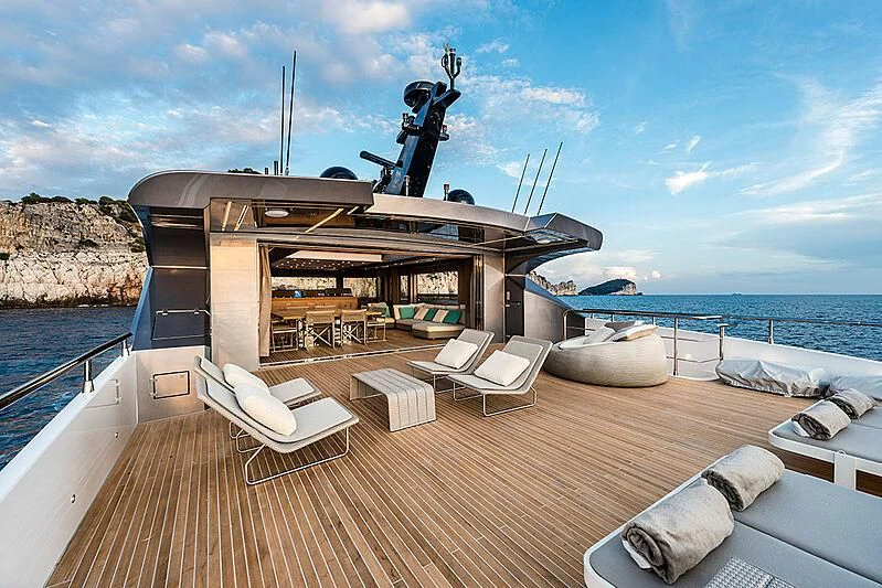 a deck with a boat and chairs on it aboard LADY NINA Yacht for Sale