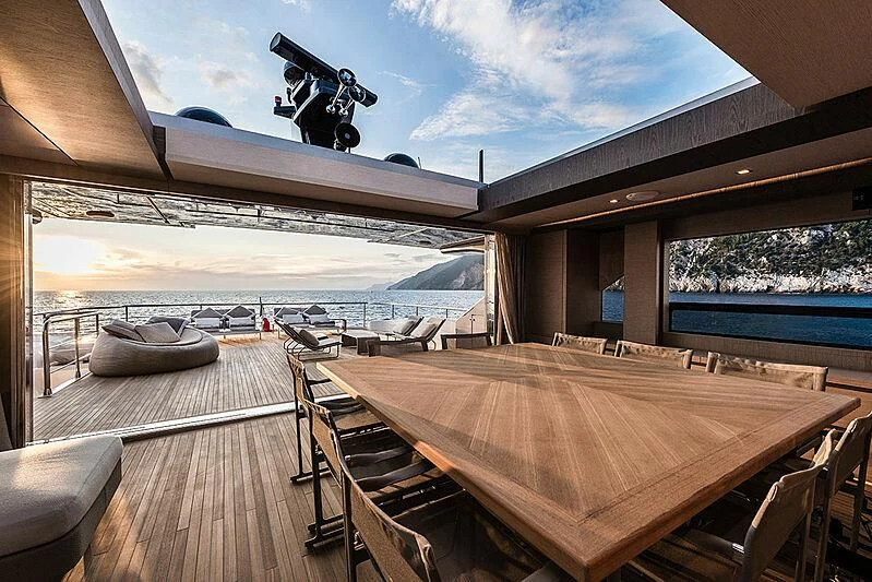 a deck with a table and chairs on it aboard LADY NINA Yacht for Sale