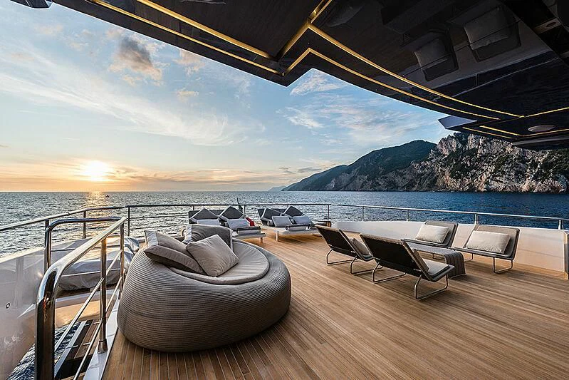 a deck with chairs and a body of water in the background aboard LADY NINA Yacht for Sale