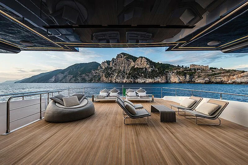 a deck with chairs and a body of water in the background aboard LADY NINA Yacht for Sale
