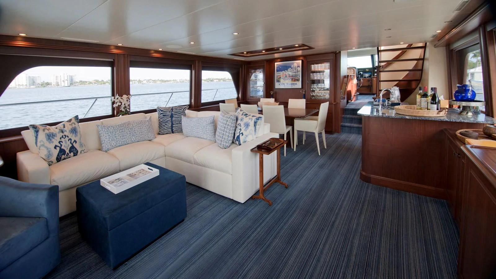 a large living room with a large gray couch and a large window aboard MONCRII Yacht for Sale