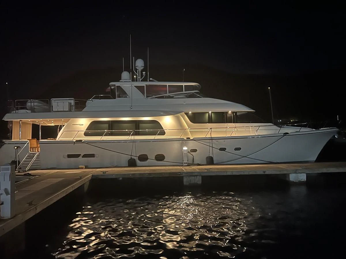 a large white yacht at night aboard MONCRII Yacht for Sale