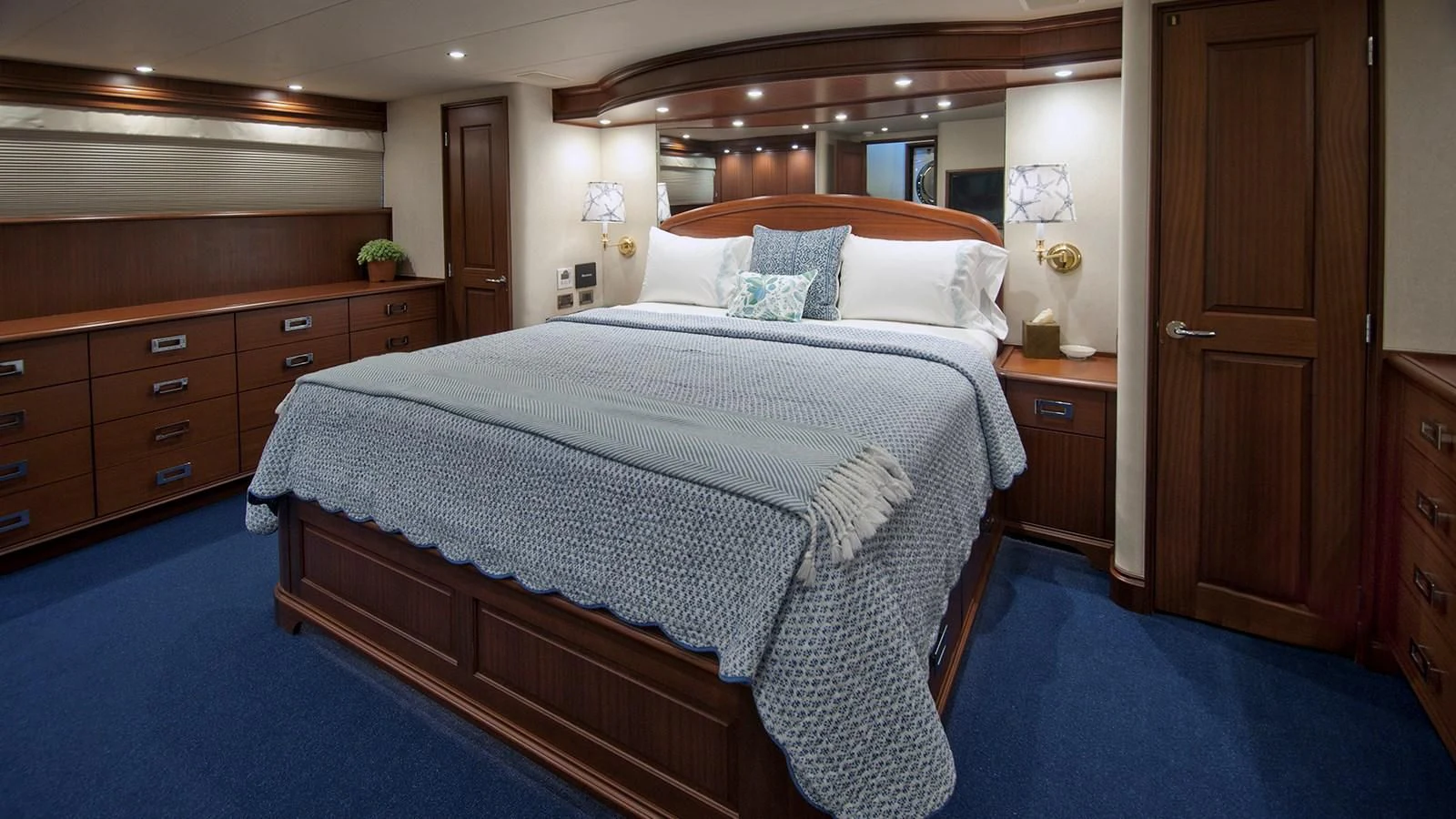 a bedroom with a bed and dresser aboard MONCRII Yacht for Sale