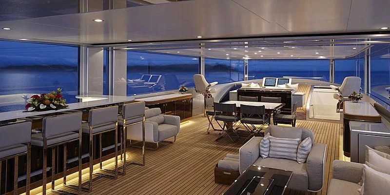 a room with a couch and a table and chairs aboard EXCELLENCE V Yacht for Sale