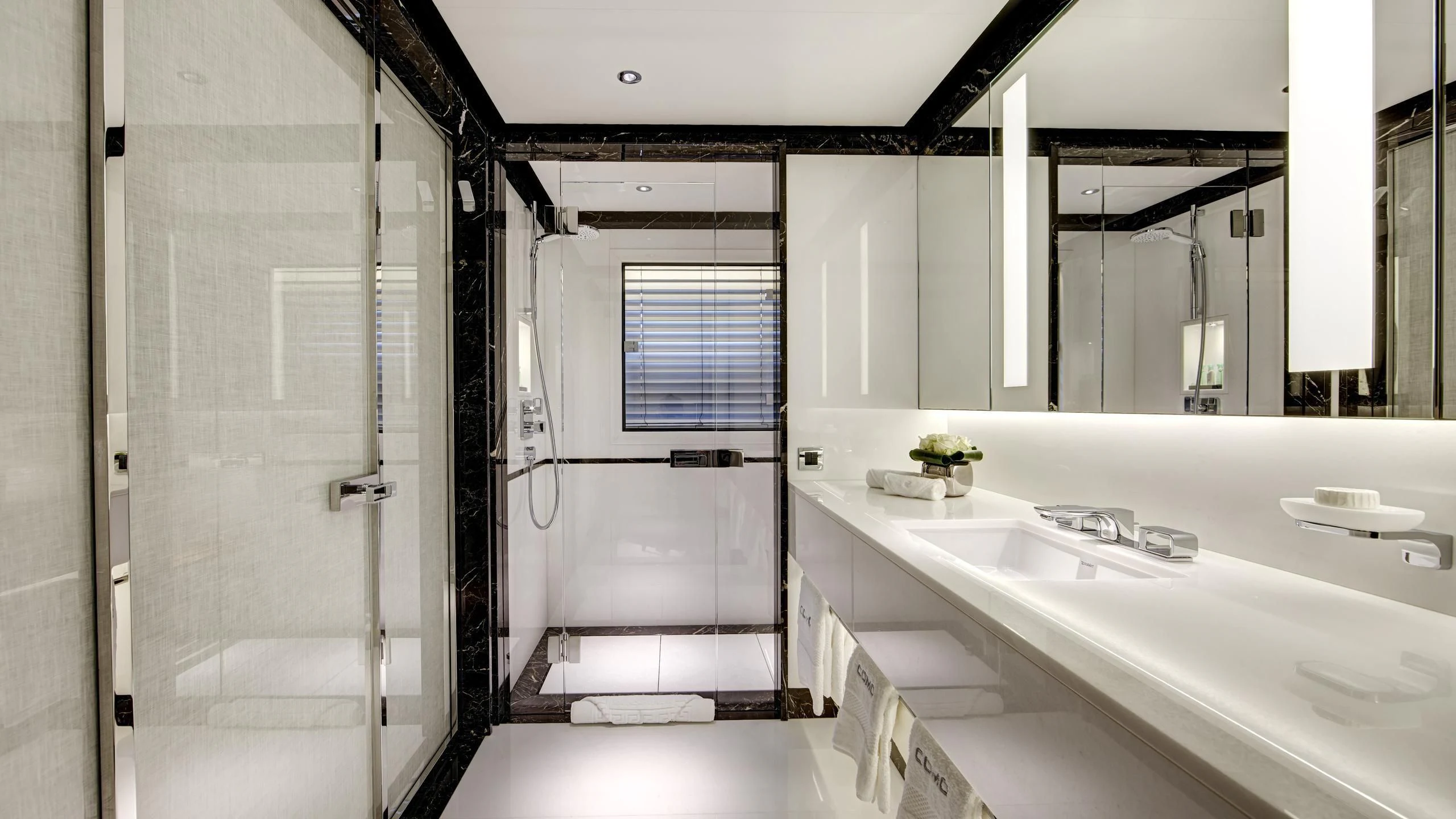 a bathroom with a shower and sinks aboard EXCELLENCE V Yacht for Sale