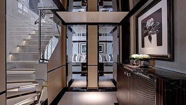 a room with a glass door and a table with chairs aboard EXCELLENCE V Yacht for Sale