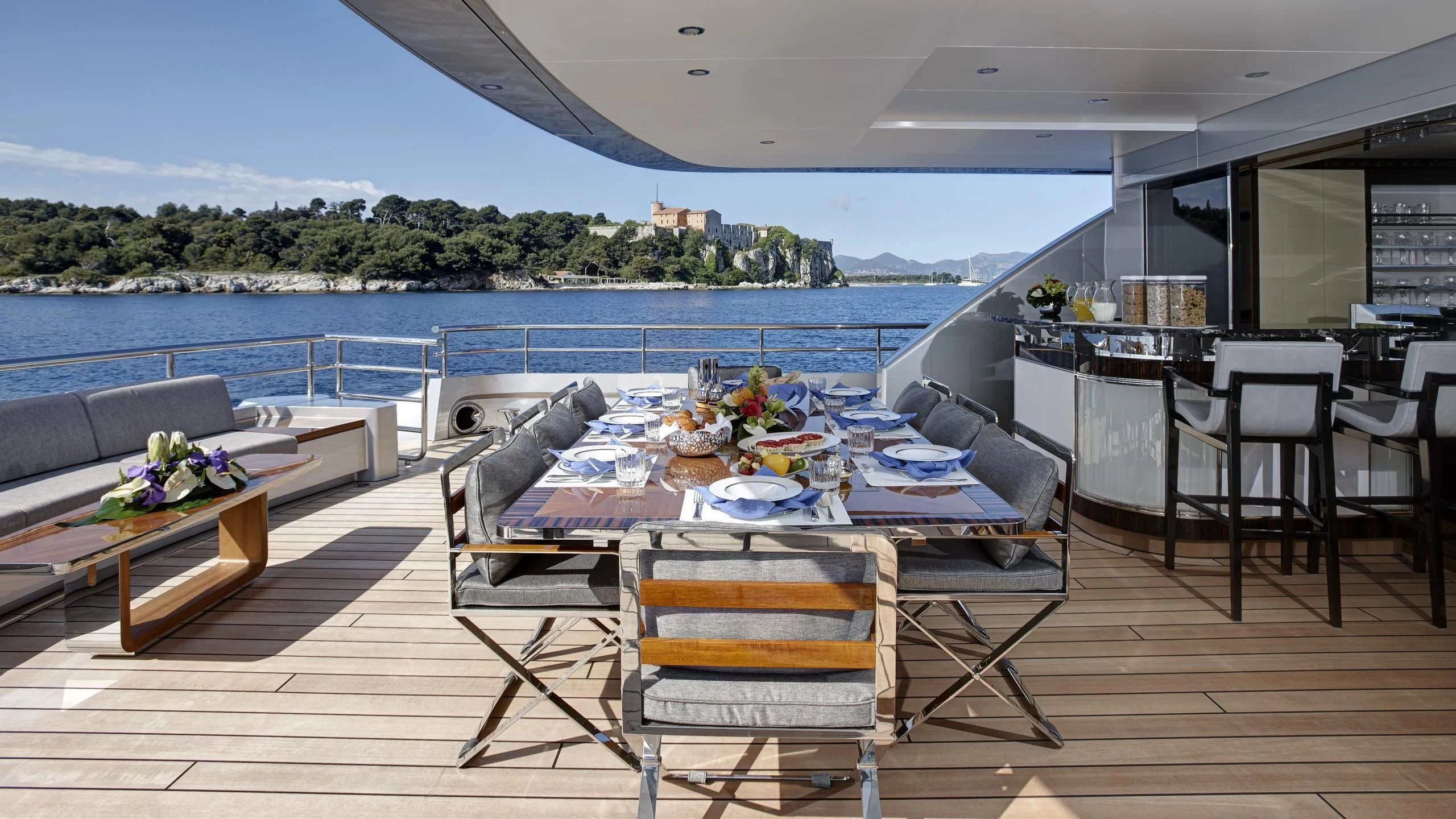 a patio with a table and chairs aboard EXCELLENCE V Yacht for Sale