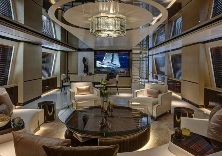 a living room with a large chandelier aboard EXCELLENCE V Yacht for Sale