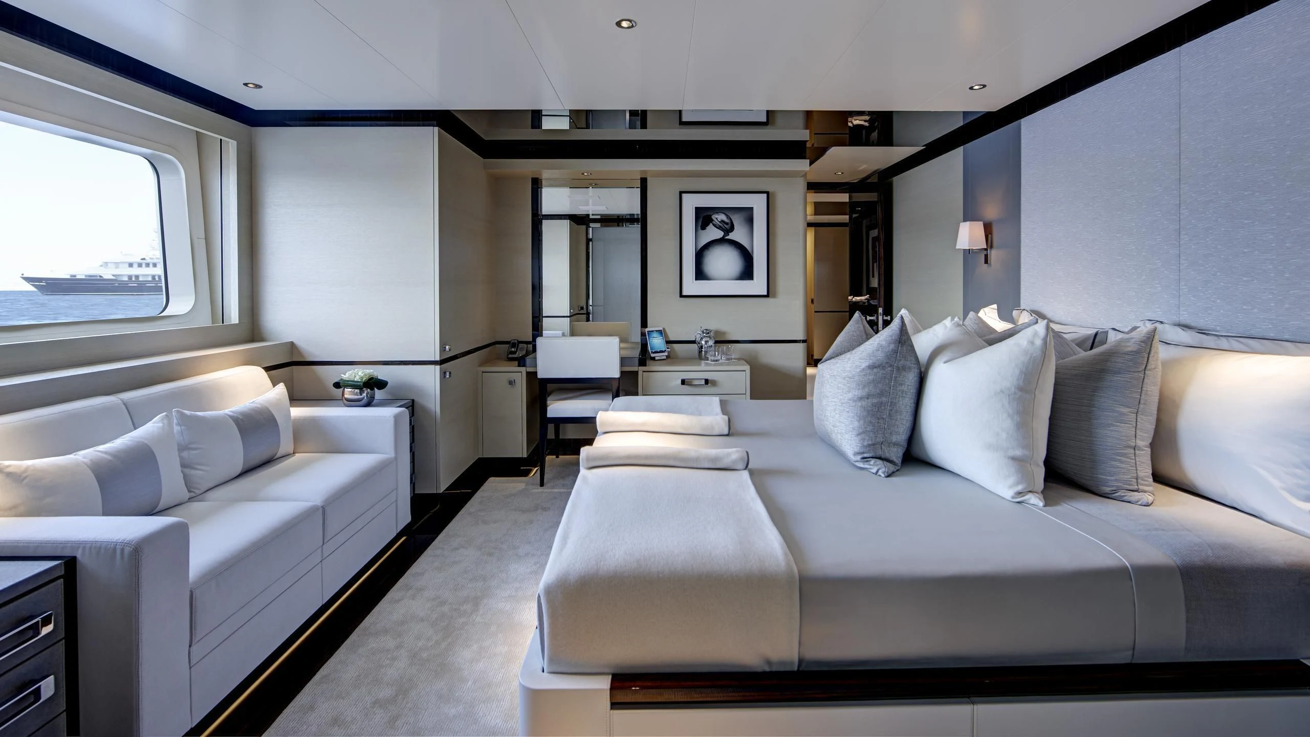 a room with a bed and a couch aboard EXCELLENCE V Yacht for Sale