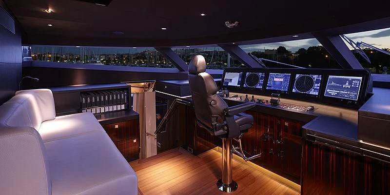 a person sitting in a chair in a room with a large screen aboard EXCELLENCE V Yacht for Sale