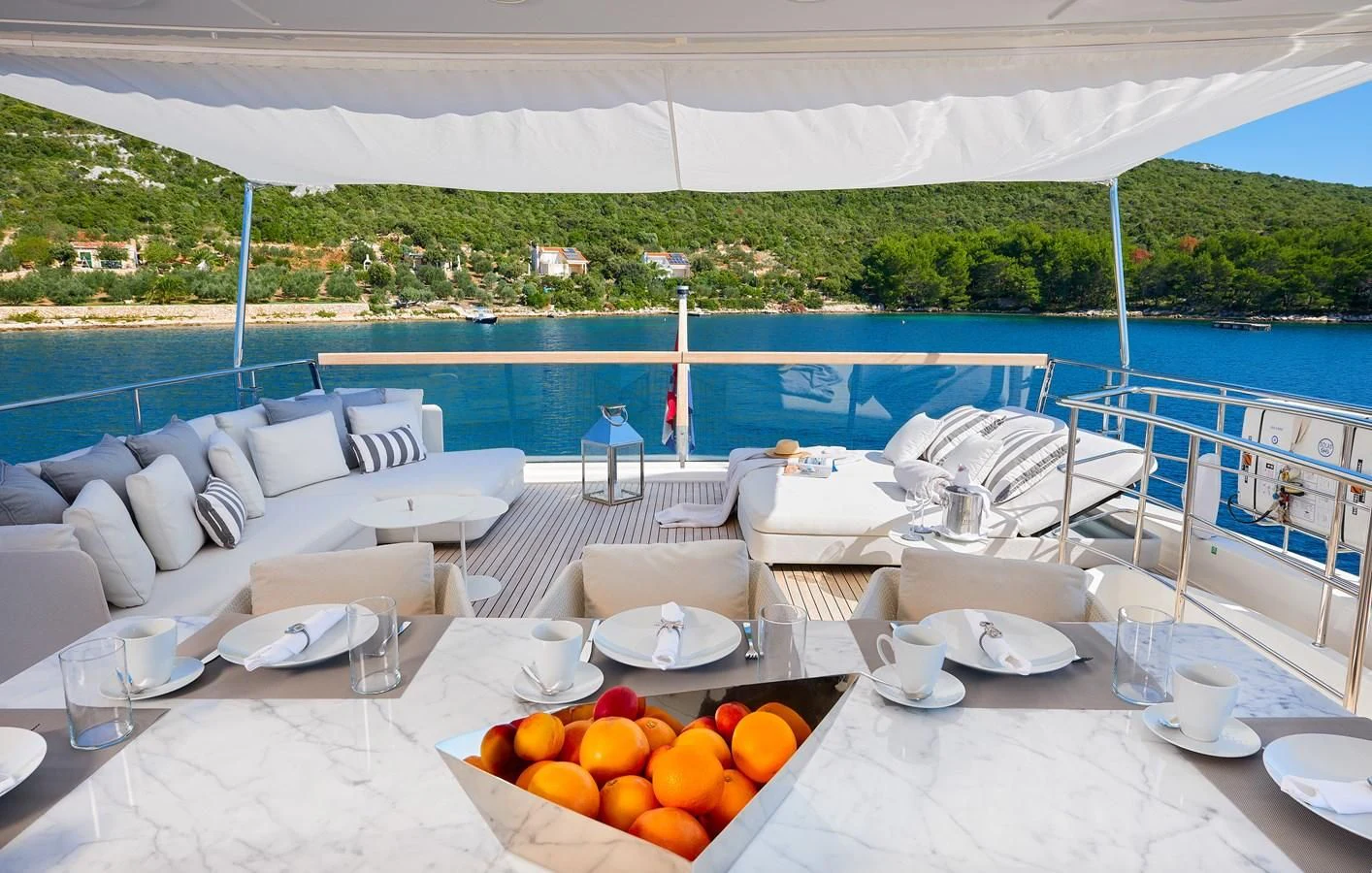 a table with plates and fruit on it aboard 2011 SANLORENZO SD92 FLYBRIDGE Yacht for Sale