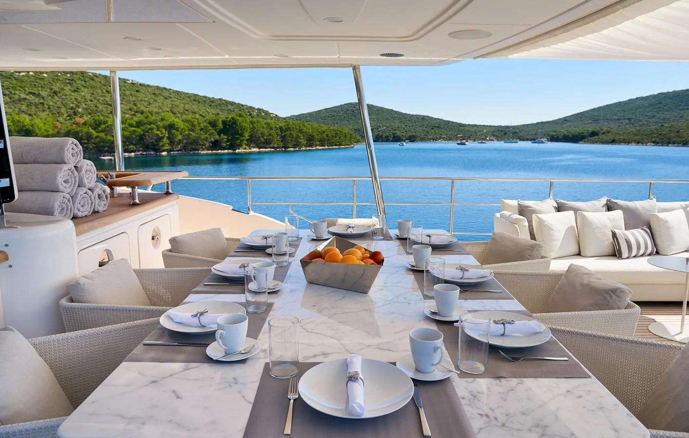 a table with plates and cups on it aboard 2011 SANLORENZO SD92 FLYBRIDGE Yacht for Sale