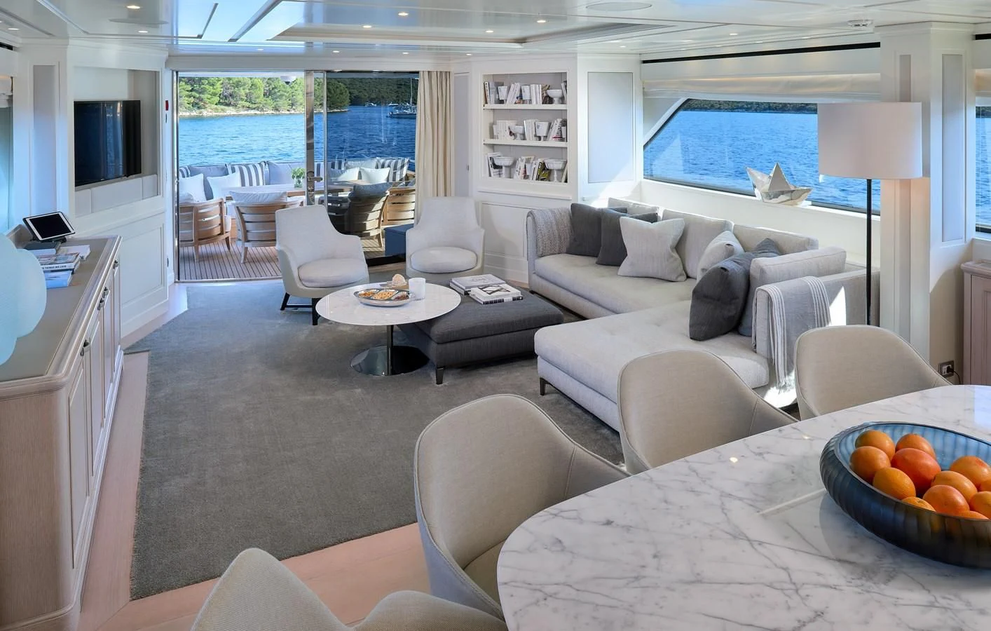 a living room with a large window aboard 2011 SANLORENZO SD92 FLYBRIDGE Yacht for Sale