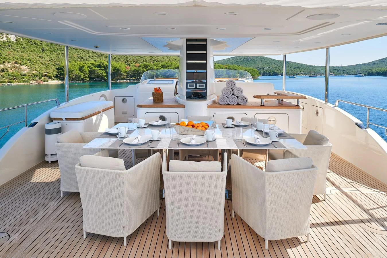 a table with chairs around it aboard 2011 SANLORENZO SD92 FLYBRIDGE Yacht for Sale