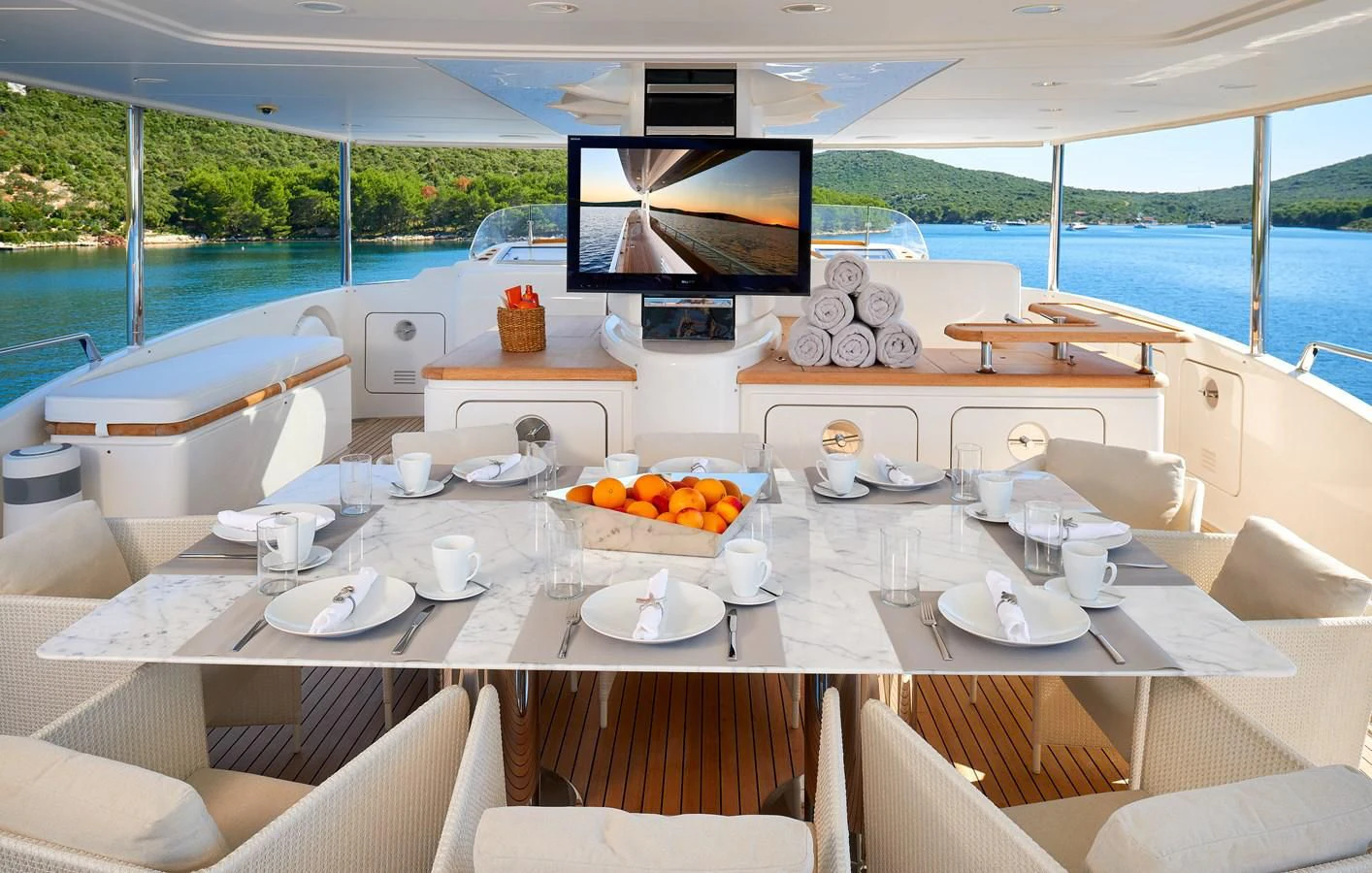 a table with plates and cups on it aboard 2011 SANLORENZO SD92 FLYBRIDGE Yacht for Sale