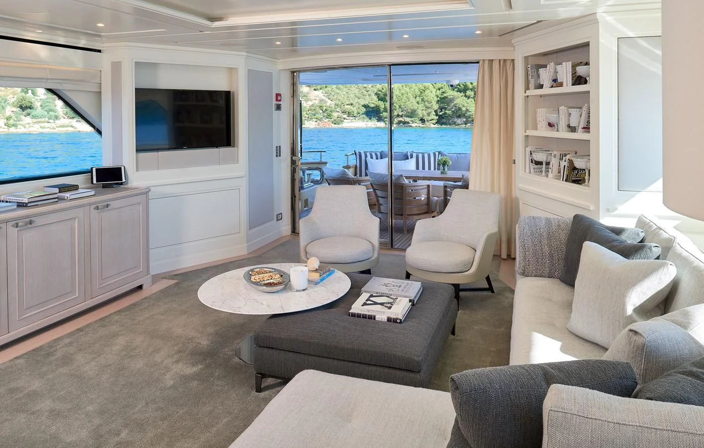 a living room with a table and chairs aboard 2011 SANLORENZO SD92 FLYBRIDGE Yacht for Sale