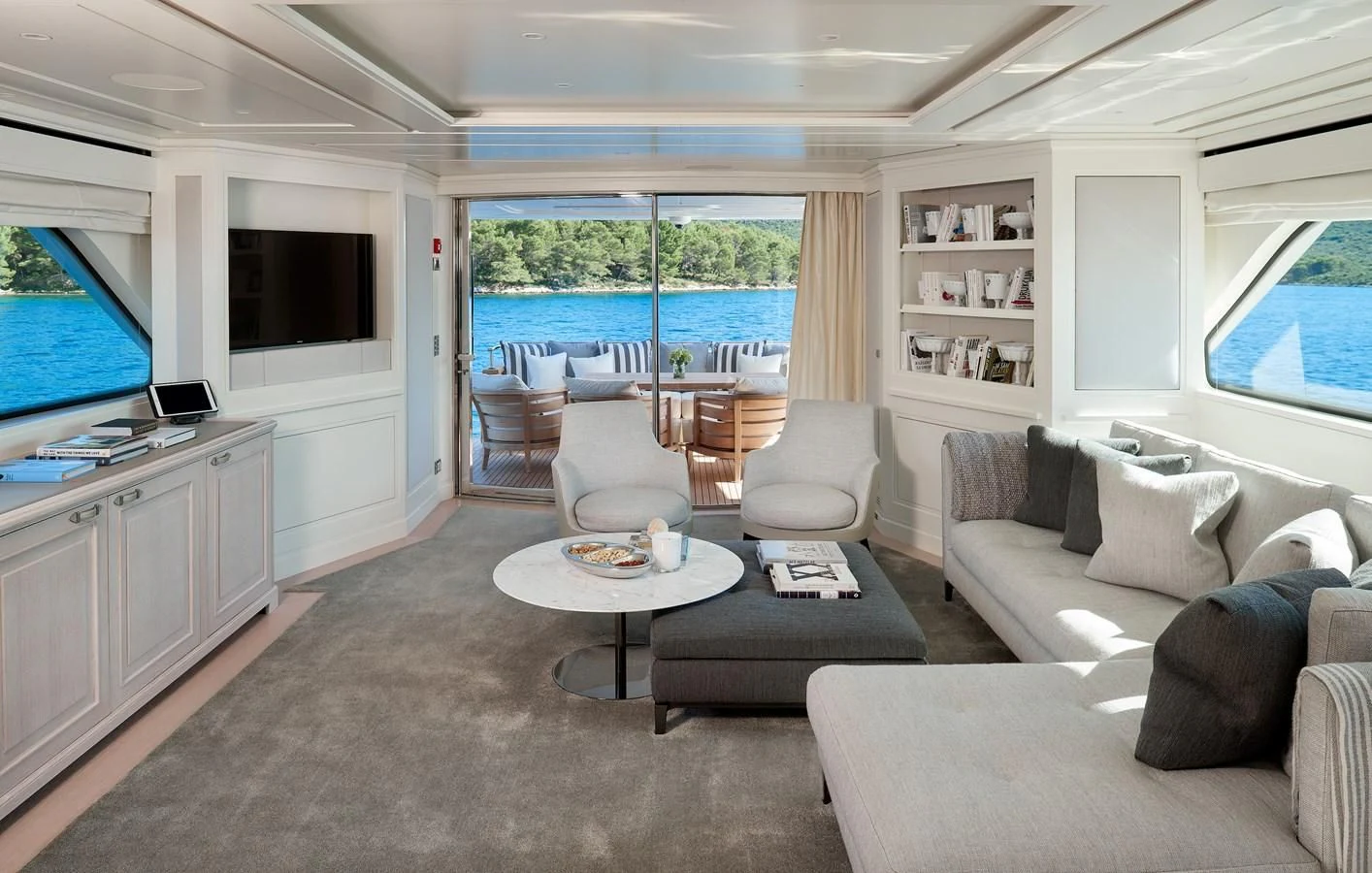 a living room with a large window aboard 2011 SANLORENZO SD92 FLYBRIDGE Yacht for Sale