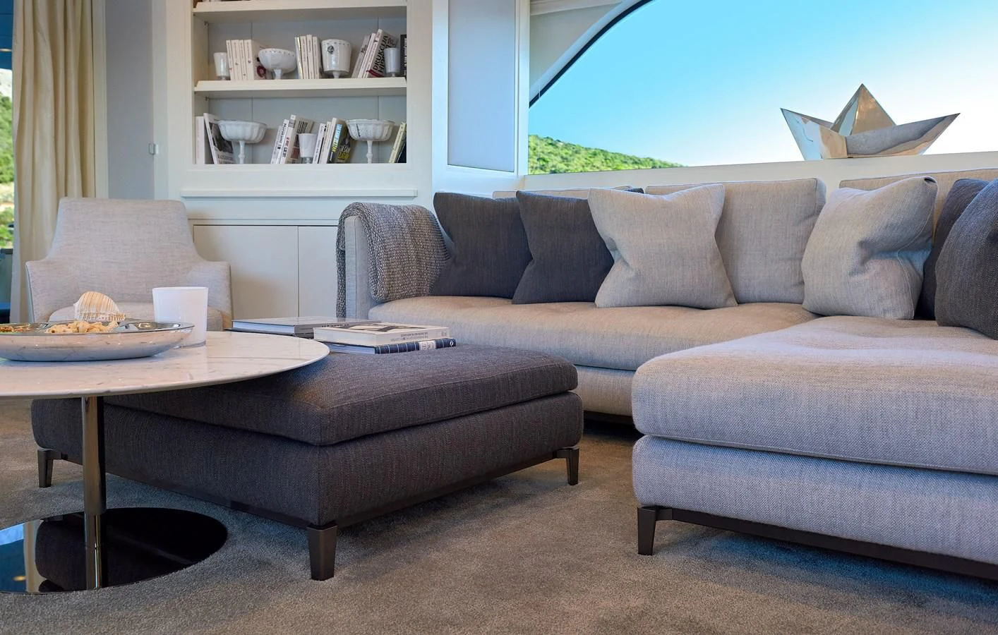 a couch and a table in a room aboard 2011 SANLORENZO SD92 FLYBRIDGE Yacht for Sale