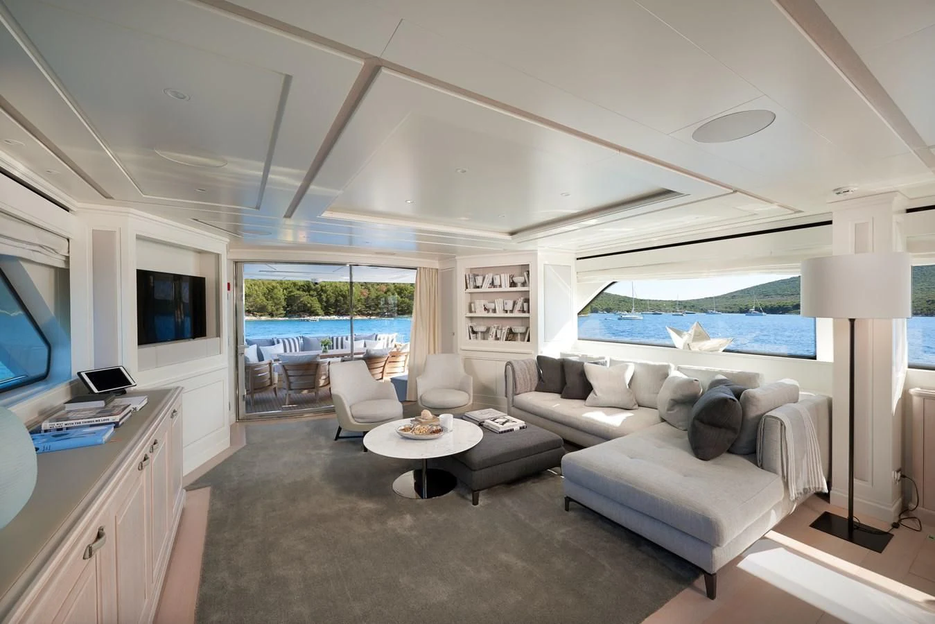 a living room with a large window aboard 2011 SANLORENZO SD92 FLYBRIDGE Yacht for Sale