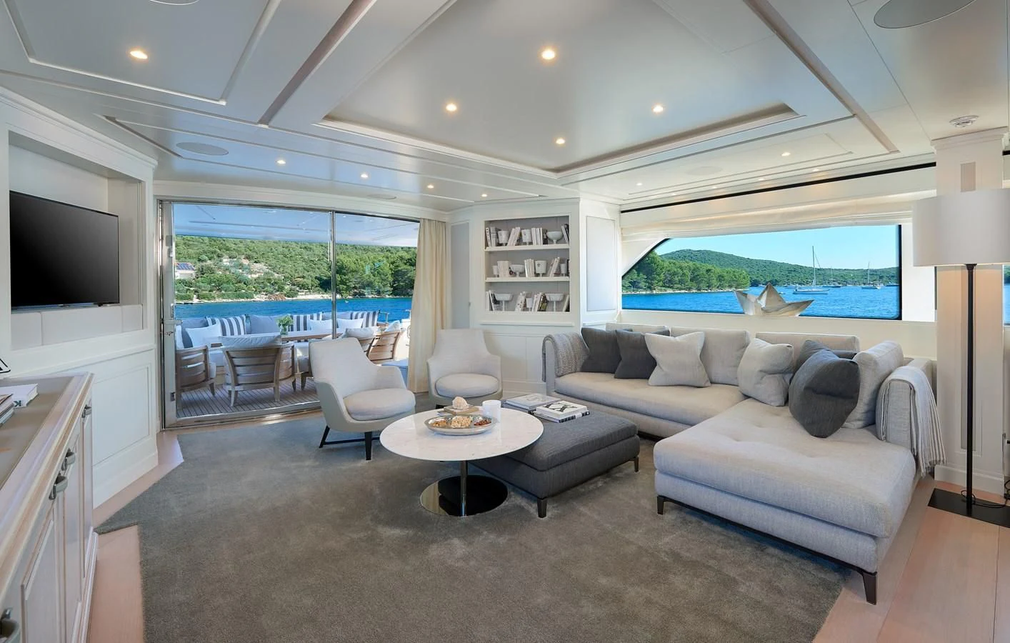 a living room with a large window aboard 2011 SANLORENZO SD92 FLYBRIDGE Yacht for Sale