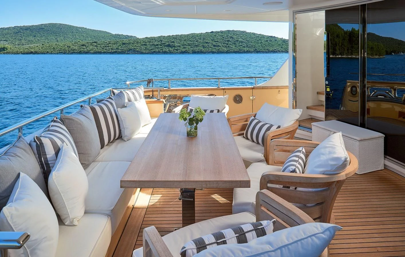 a table and chairs on a boat aboard 2011 SANLORENZO SD92 FLYBRIDGE Yacht for Sale
