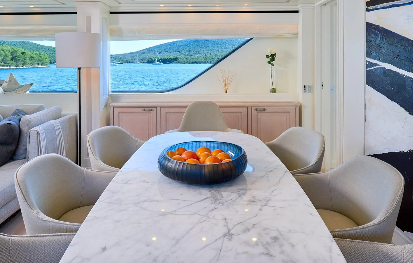 a bowl of oranges on a table in a living room aboard 2011 SANLORENZO SD92 FLYBRIDGE Yacht for Sale